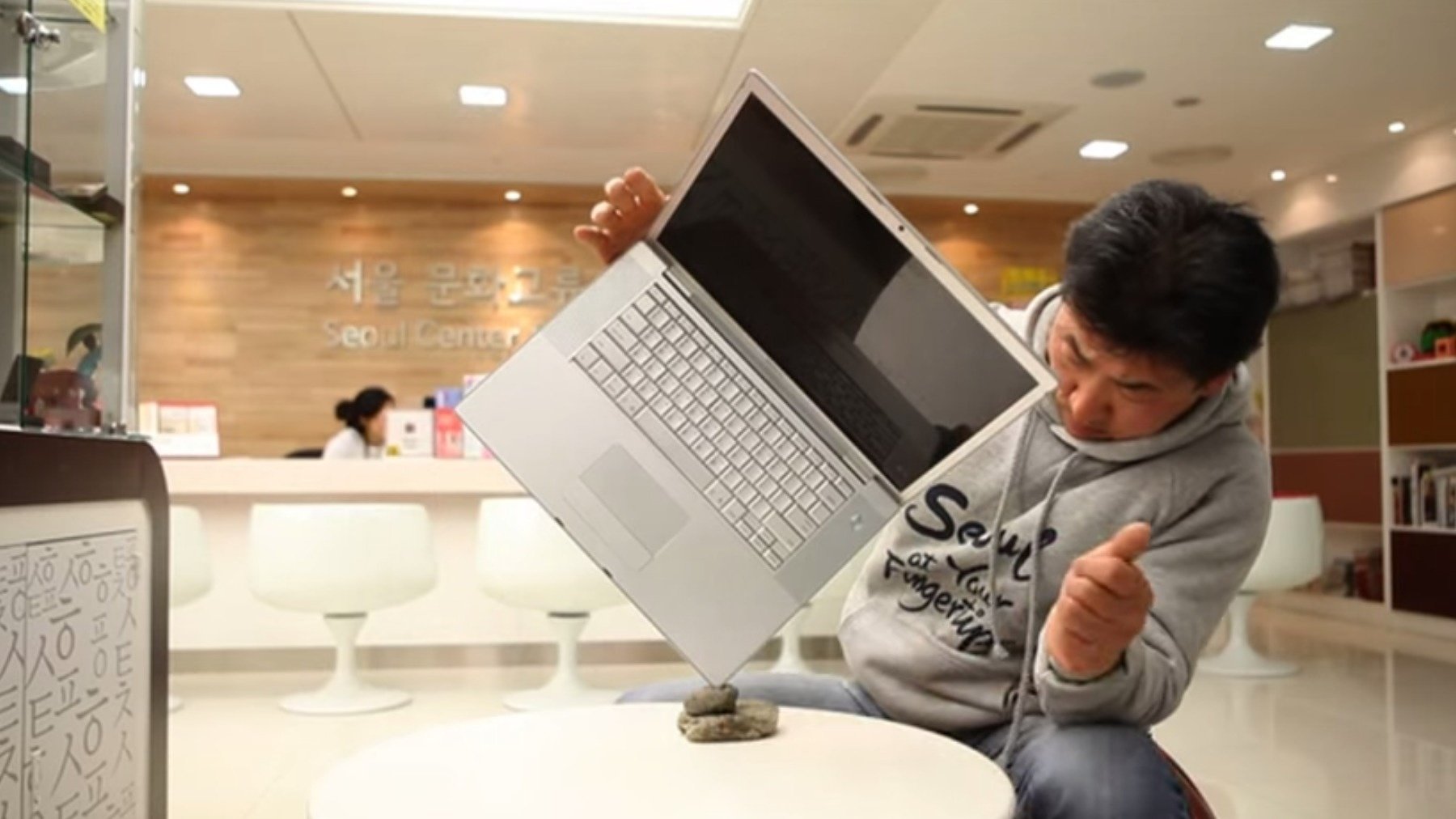 Man balancing laptop